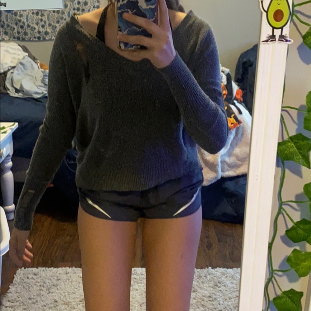 Loose/thin grey sweater w/ rips.